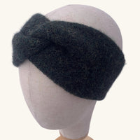 Dark gray knitted headband on a mannequin head against a white background