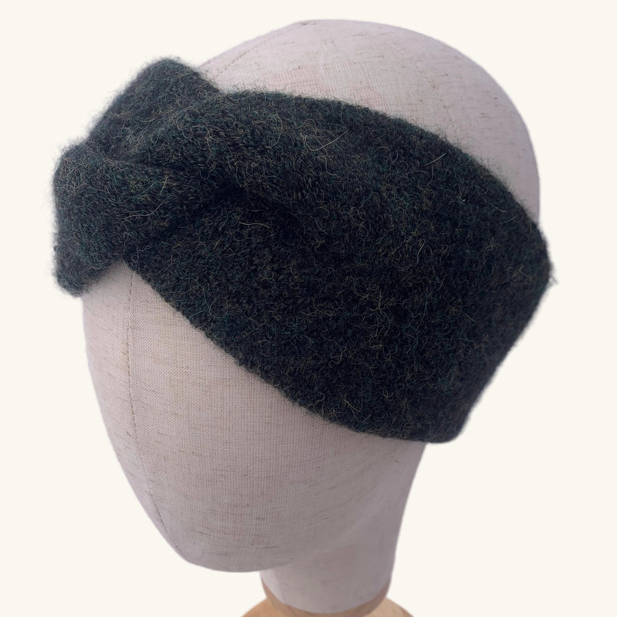 Dark gray knitted headband on a mannequin head against a white background