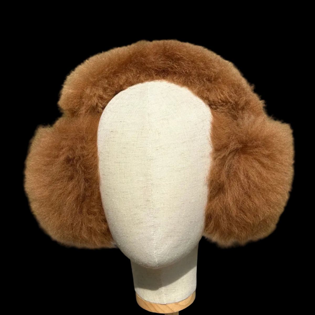 A brown fur earmuff displayed on a cream fabric mannequin head.