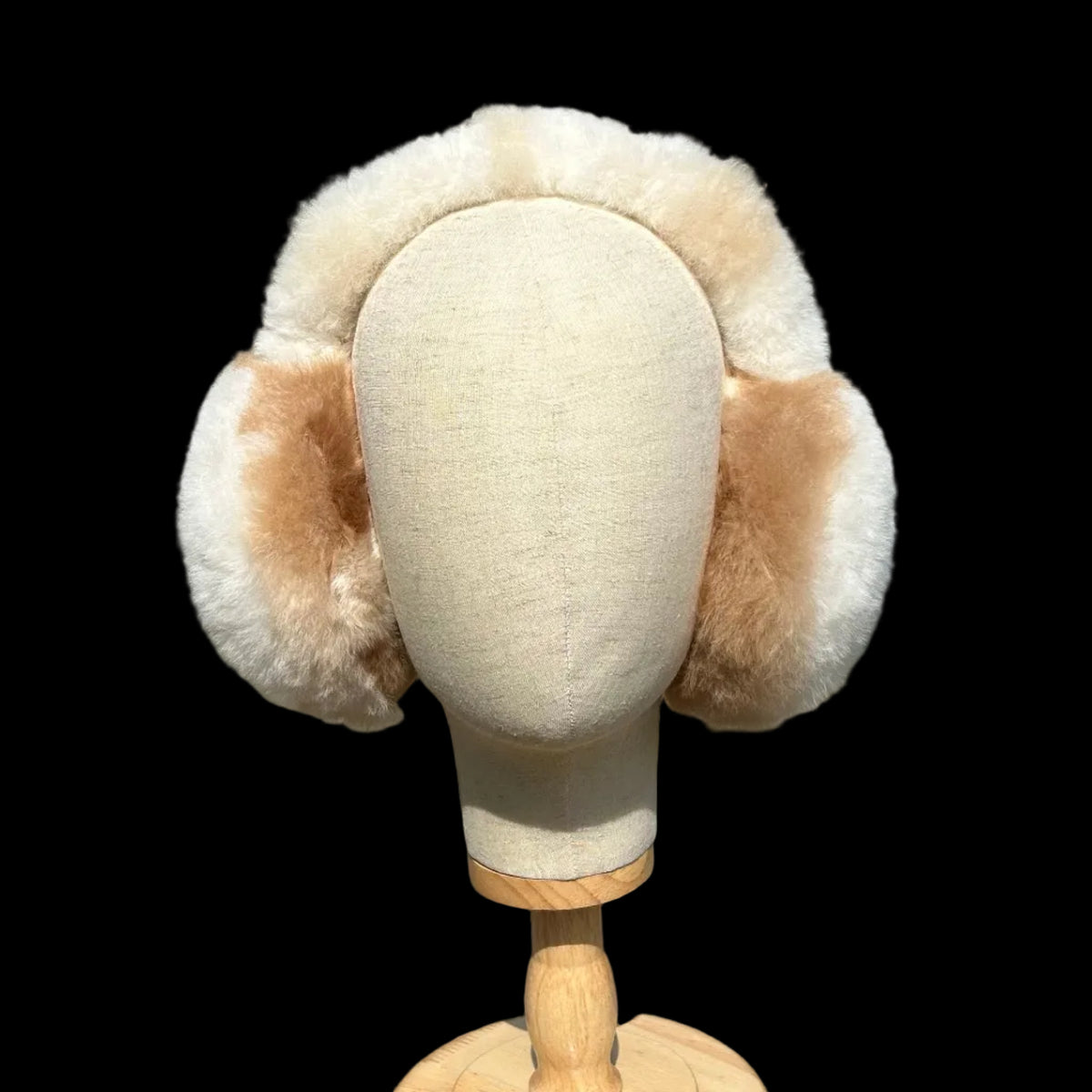A cream-colored head accessory with multi coloured fluffy earmuffs.