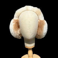 A cream-colored head accessory with multi coloured fluffy earmuffs.